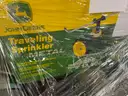 Lot of JD Traveling Tractor Sprinkler, Air Compressors, Seed Spreader, and Other Tools