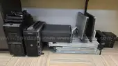 Lot of various computer equipment, tablets, monitors, and electronics.