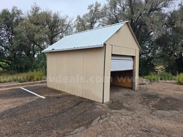 Approximate 15&#x27; 10&#x22; x 11&#x27; 9&#x22; building with garage door