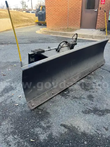 Snow plow for skid loader