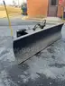 Snow plow for skid loader