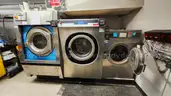 Lot of Commercial Laundry Equipment: Three (3) Washers, Three (3) Dryers with Chemical Pumps
