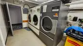 Lot of Commercial Laundry Equipment: Three (3) Washers, Three (3) Dryers with Chemical Pumps