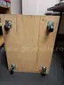 Two blonde wood boxes on casters
