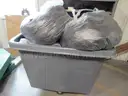 Several Bags Of Black Utility Pants