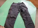 Several Bags Of Black Utility Pants