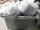 Several Bags Of Black Utility Pants