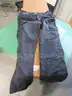Several Bags Of Black Utility Pants