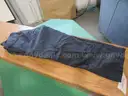 Several Bags Of Black Utility Pants