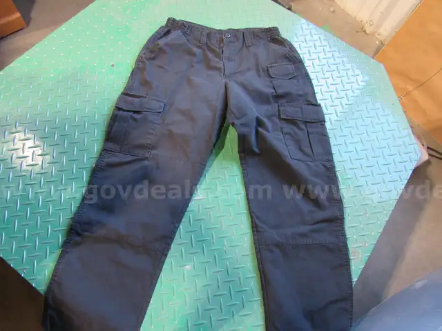 Several Bags Of Black Utility Pants