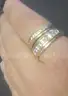 2 gold coloured rings with clear stones