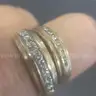 2 gold coloured rings with clear stones