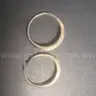 2 gold coloured rings with clear stones