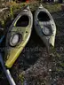 2 sit in Kayaks