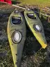 2 sit in Kayaks