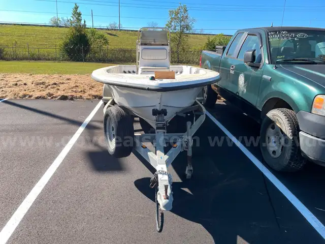 LOT OF A BOAT WITH TRAILER AND MOTOR