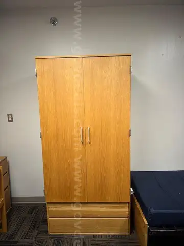 dormitory furniture, including beds, desk, wardrobes, and chairs.