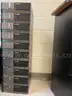 Lot of computer monitors, workstations, and keyboards - Used