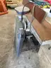 Used industrial woodworking jointer mounted on a metal stand