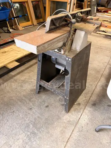 Used industrial woodworking jointer mounted on a metal stand