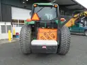 John Deere 6115M with extended mower attachment.