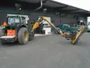 John Deere 6115M with extended mower attachment.