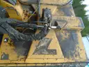 John Deere 6115M with extended mower attachment.