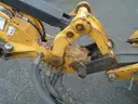 John Deere 6115M with extended mower attachment.