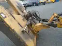 John Deere 6115M with extended mower attachment.