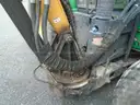 John Deere 6115M with extended mower attachment.