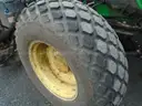 John Deere 6115M with extended mower attachment.