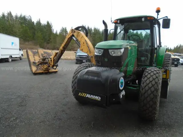 John Deere 6115M with extended mower attachment.