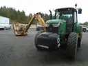 John Deere 6115M with extended mower attachment.