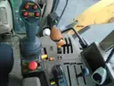 John Deere 6115M with extended mower attachment.