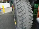 John Deere 6115M with extended mower attachment.