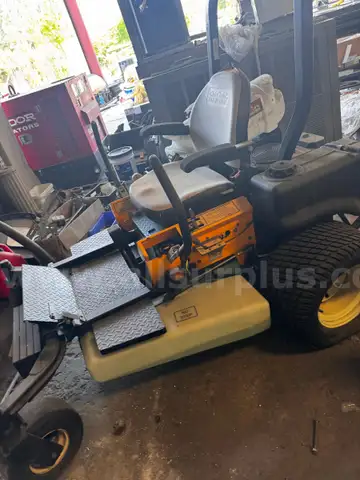 Cub Cadet Commercial Tank Zero Turn Mower equipped with a &#x22;ride-on sprayer&#x22; attachment,