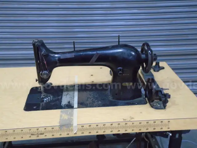 Vintage  sewing machine with table. Table has foot and knee pedal