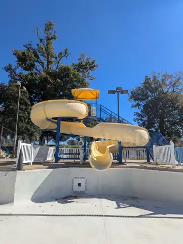 USA Slide 19&#x27; Tall Pool Slide with attached Staircase and Canopy and Surrounding Fence
