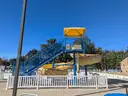 USA Slide 19&#x27; Tall Pool Slide with attached Staircase and Canopy and Surrounding Fence