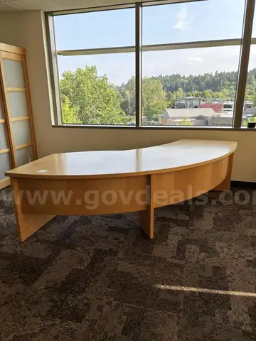 Large, curved wooden desk.