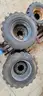 4 SKID STEER TIRES AND WHEELS