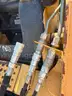 JOHN DEERE SKID STEER MODEL 315, DIESEL, ENCLOSED CAB , UNUSED ROLLER ATTACHMENT, SMOOTH TIRES, RUNS AND OPERATES