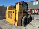 JOHN DEERE SKID STEER MODEL 315, DIESEL, ENCLOSED CAB , UNUSED ROLLER ATTACHMENT, SMOOTH TIRES, RUNS AND OPERATES