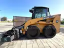 JOHN DEERE SKID STEER MODEL 315, DIESEL, ENCLOSED CAB , UNUSED ROLLER ATTACHMENT, SMOOTH TIRES, RUNS AND OPERATES