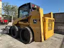 JOHN DEERE SKID STEER MODEL 315, DIESEL, ENCLOSED CAB , UNUSED ROLLER ATTACHMENT, SMOOTH TIRES, RUNS AND OPERATES