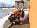 Kubota Tractor with Salt Spreader and attachment for a Plow