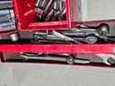 Tool box of various loose sockets, wrenches and ratchets.