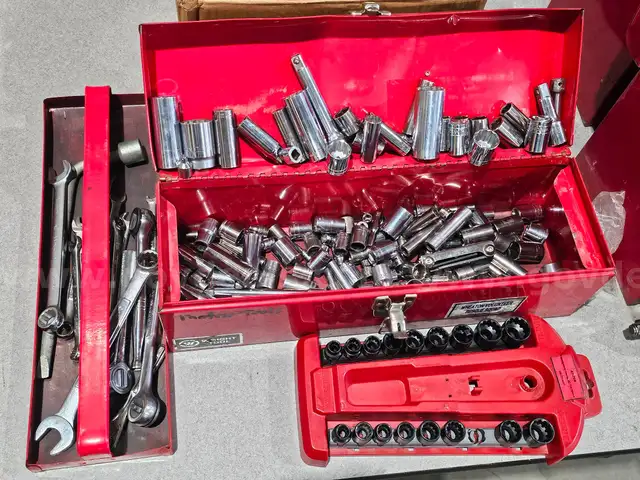 Tool box of various loose sockets, wrenches and ratchets.