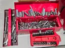 Tool box of various loose sockets, wrenches and ratchets.