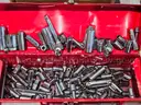 Tool box of various loose sockets, wrenches and ratchets.